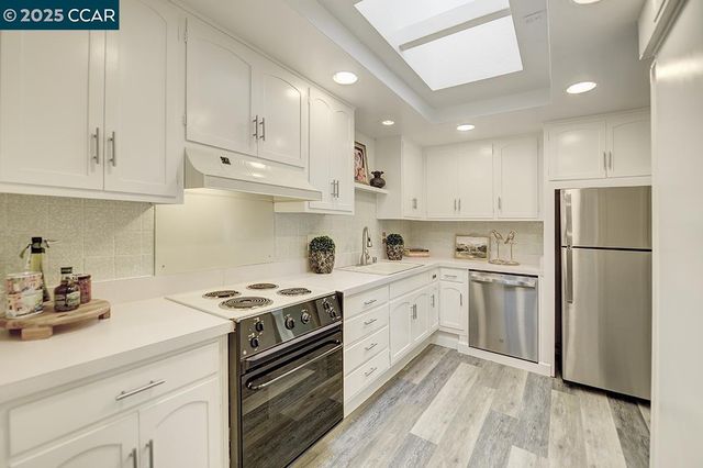 a kitchen with cabinets appliances cabinets and a sink