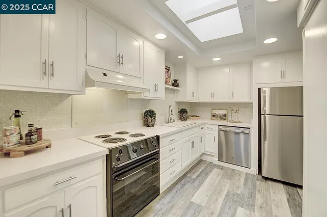 a kitchen with cabinets appliances cabinets and a sink