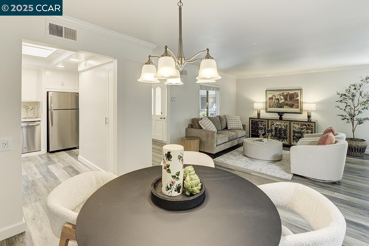 1315 Golden Rain Road, Unit 2 Walnut Creek, CA 94595 - Photo 20 of 54 a living room with furniture and a chandelier