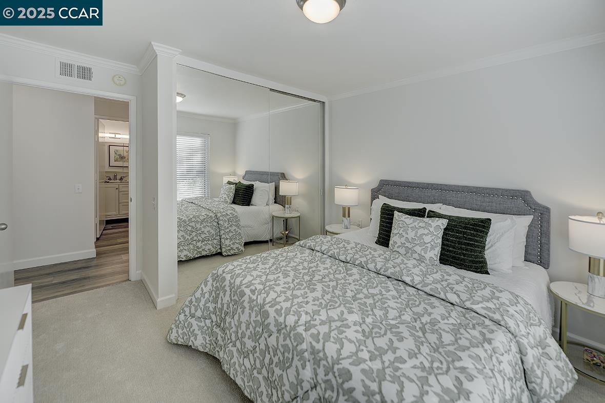 1315 Golden Rain Road, Unit 2 Walnut Creek, CA 94595 - Photo 26 of 54 a bedroom with a bed and glass door