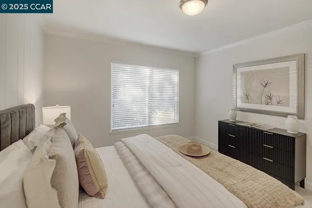 a bedroom with a bed and cabinet