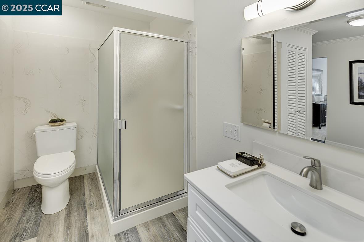 1315 Golden Rain Road, Unit 2 Walnut Creek, CA 94595 - Photo 35 of 54 a bathroom with a sink toilet and a mirror