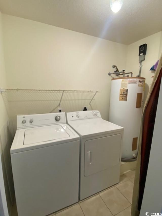 2265 Huntingdon Drive, Unit A Surfside Beach, SC 29575 - Photo 14 of 18 Laundry area with washing machine and dryer, electric water heater, and light tile patterned flooring