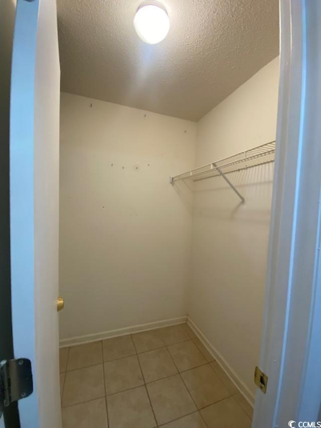 2265 Huntingdon Drive, Unit A Surfside Beach, SC 29575 - Photo 8 of 18 Walk in closet featuring light tile patterned floors