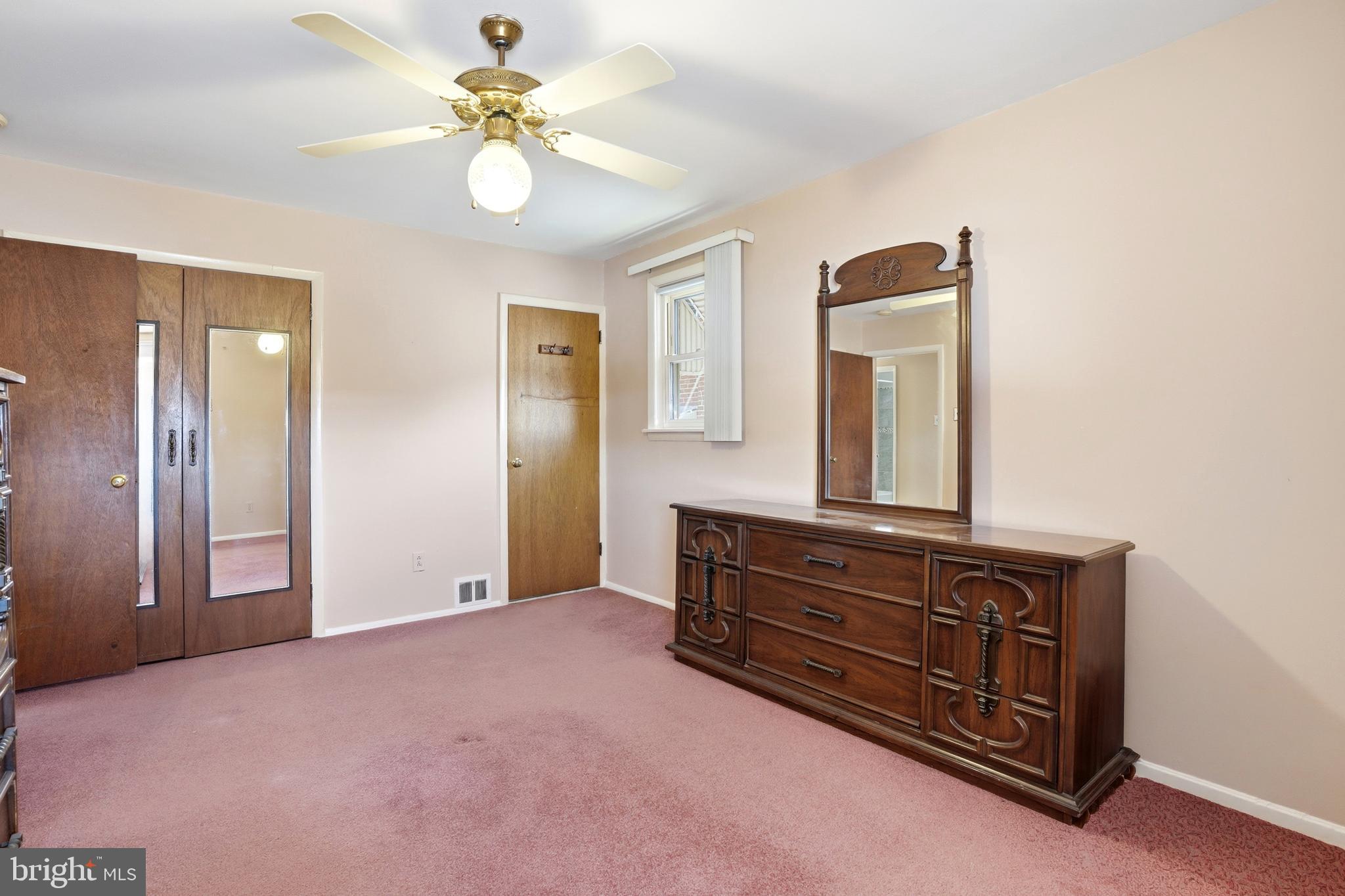 8931 Leonard Street Philadelphia, PA 19152 - Photo 21 of 52 a room with a dresser and a chandelier