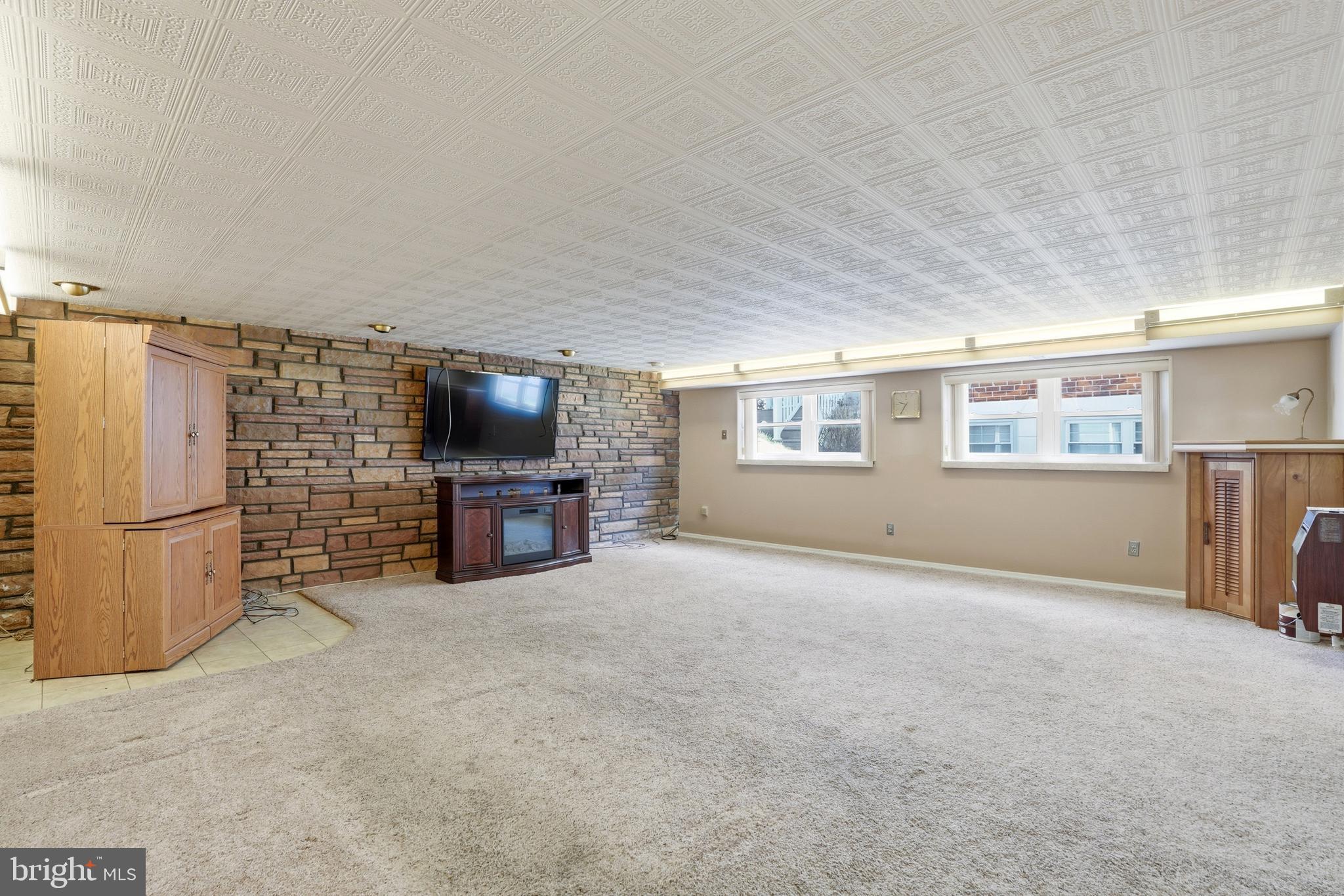 8931 Leonard Street Philadelphia, PA 19152 - Photo 26 of 52 a living room with a fireplace furniture and a flat screen tv