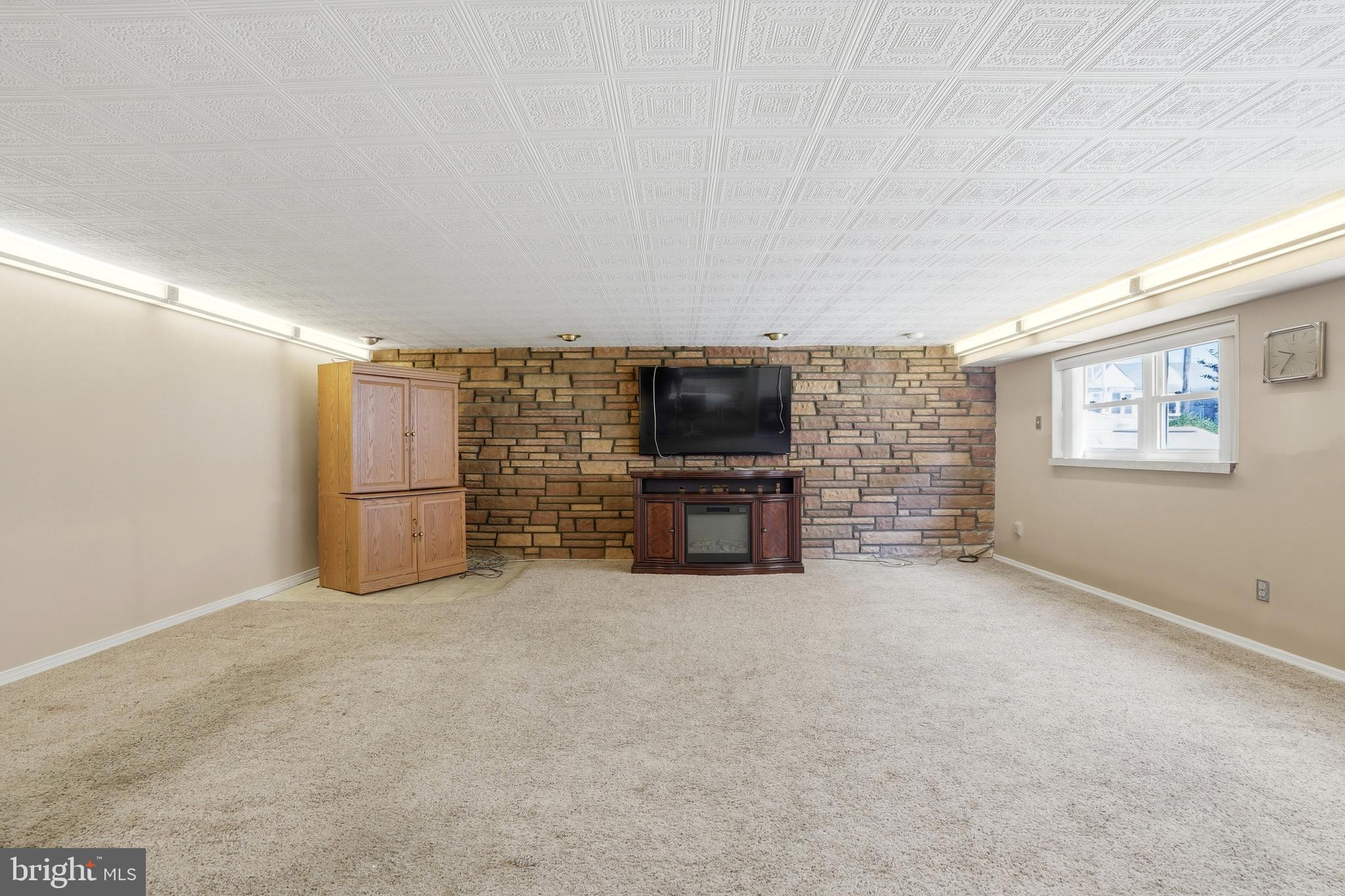 8931 Leonard Street Philadelphia, PA 19152 - Photo 27 of 52 an empty room with furniture and a flat screen tv