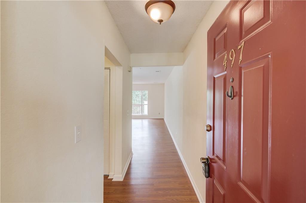 497 Sherman Way Decatur, GA 30033 - Photo 1 of 1 a view of a hallway with wooden floor and staircase