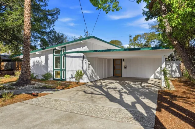 a view of a hallway with wooden floor and closet