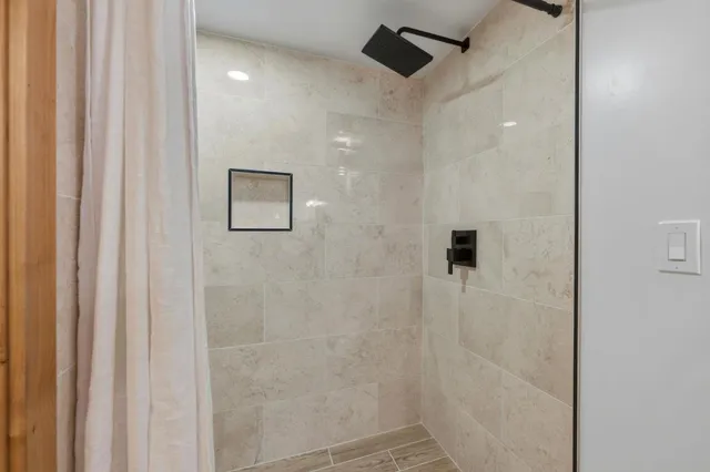 a living room with furniture a rug and a table