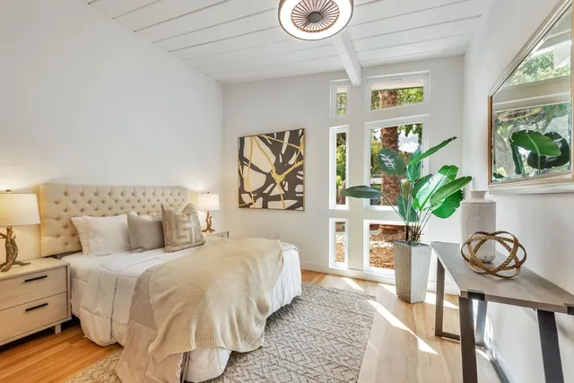 a bedroom with bed and a night stand