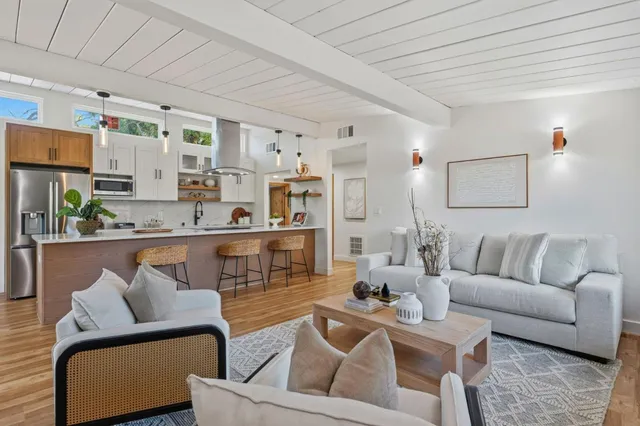 a kitchen with a sink a stove and chairs