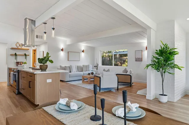 a dining room with furniture and wooden floor