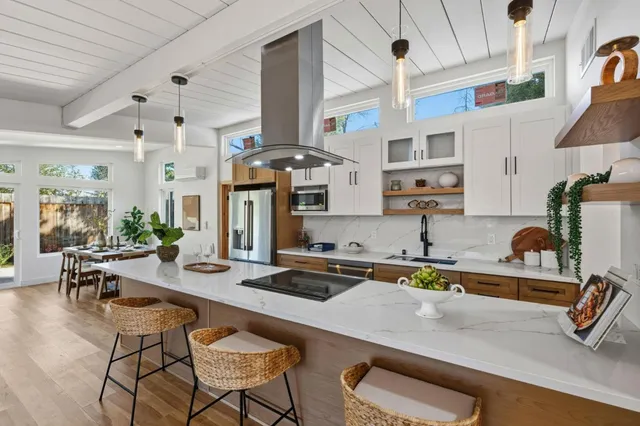 a room with a potted plant on the counter and cabinets