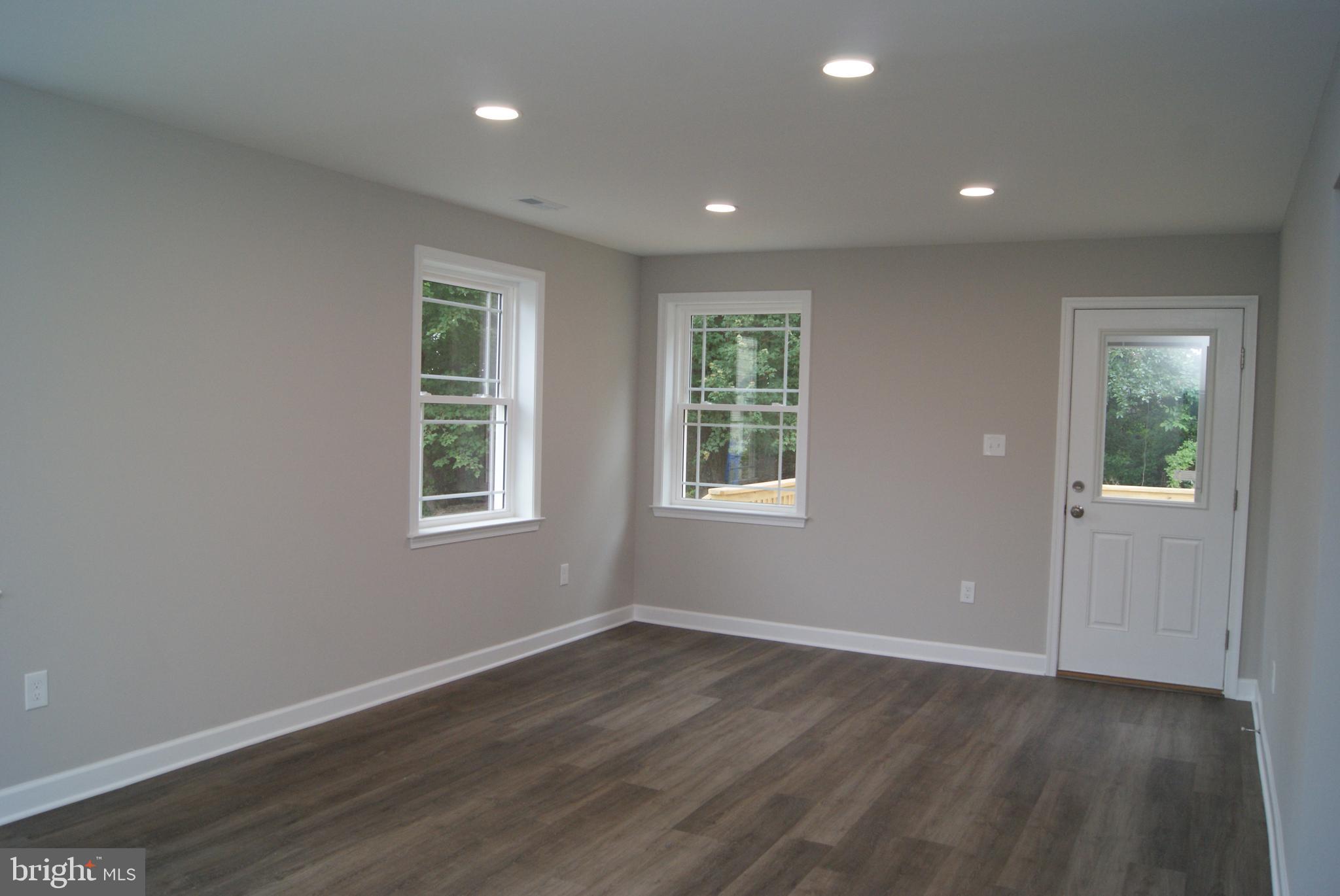 3702 Nichol Street Bristol, PA 19007 - Photo 5 of 7 an empty room with wooden floor and windows