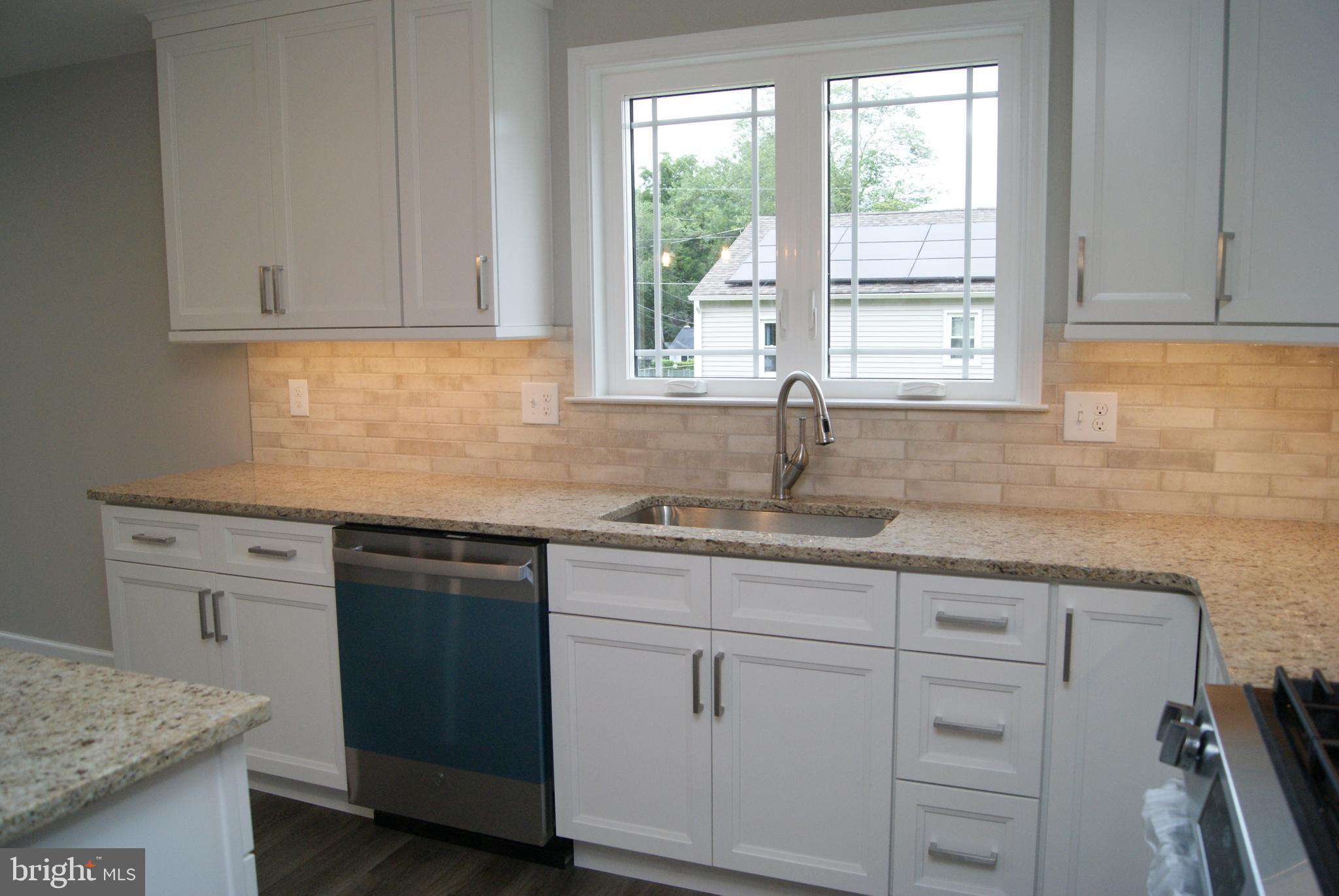 3702 Nichol Street Bristol, PA 19007 - Photo 6 of 7 a kitchen with granite countertop white cabinets and a sink