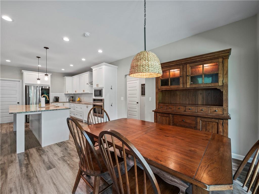 259 Cochran Road Talmo, GA 30575 - Photo 13 of 35 a kitchen with kitchen island a stove a table and chairs in it