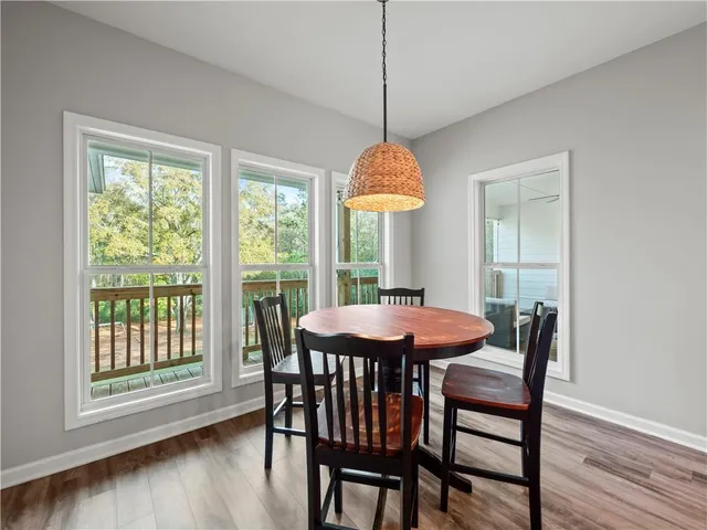 a dining room with furniture window and wooden floor