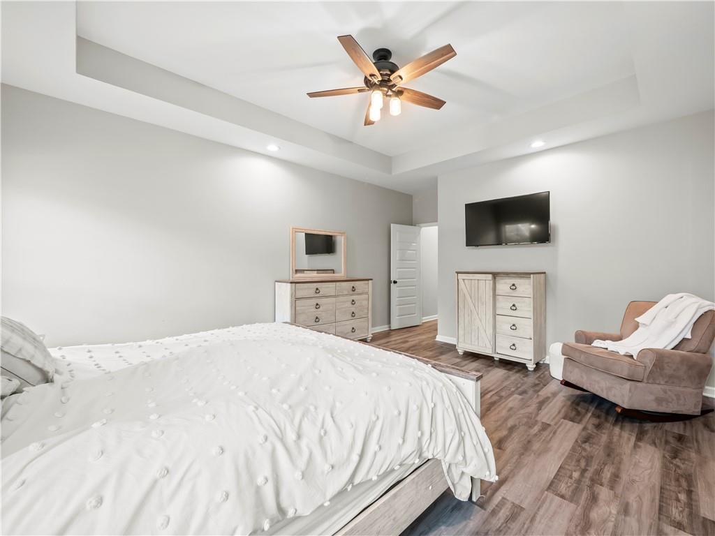 259 Cochran Road Talmo, GA 30575 - Photo 16 of 35 a spacious bedroom with a bed and a flat screen tv