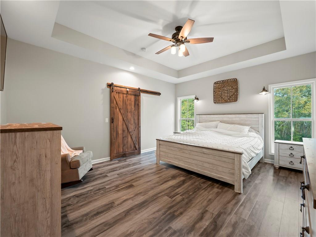 259 Cochran Road Talmo, GA 30575 - Photo 18 of 35 a bedroom with a bed and a chandelier