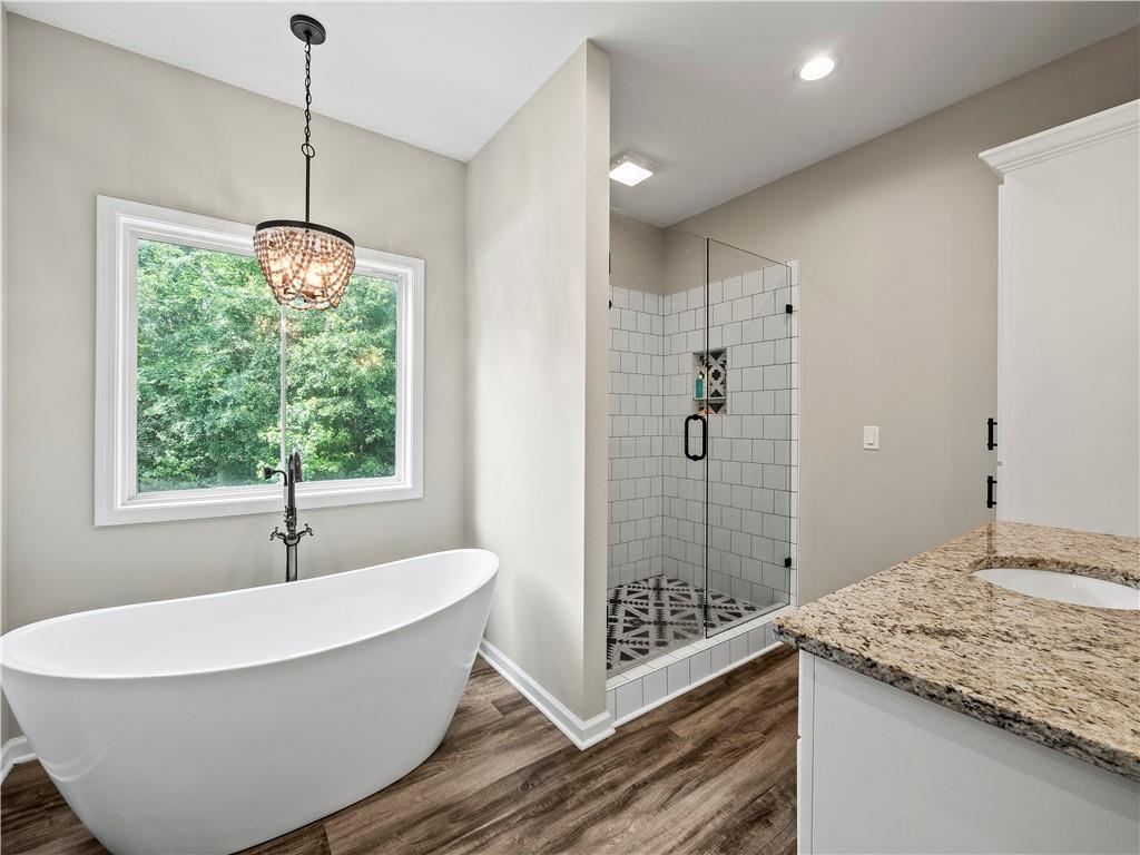 259 Cochran Road Talmo, GA 30575 - Photo 22 of 35 a spacious bathroom with a granite countertop sink and a mirror