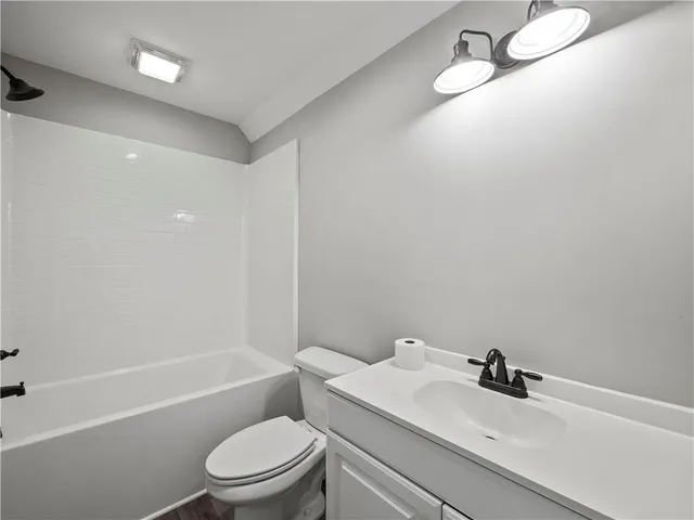 a bathroom with a sink toilet and a tub