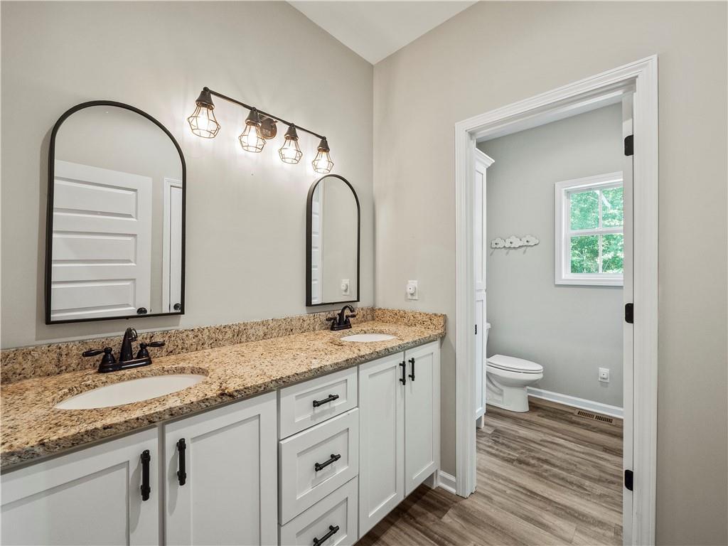 259 Cochran Road Talmo, GA 30575 - Photo 27 of 35 a bathroom with a granite countertop sink and a mirror