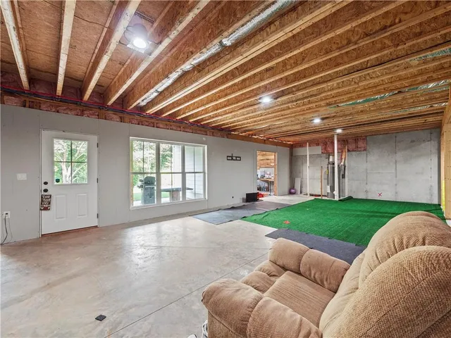 a bed room with a bed and a large window