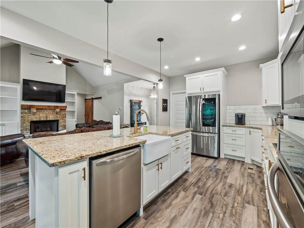 259 Cochran Road Talmo, GA 30575 - Photo 7 of 35 a kitchen with stainless steel appliances granite countertop a sink stove and refrigerator