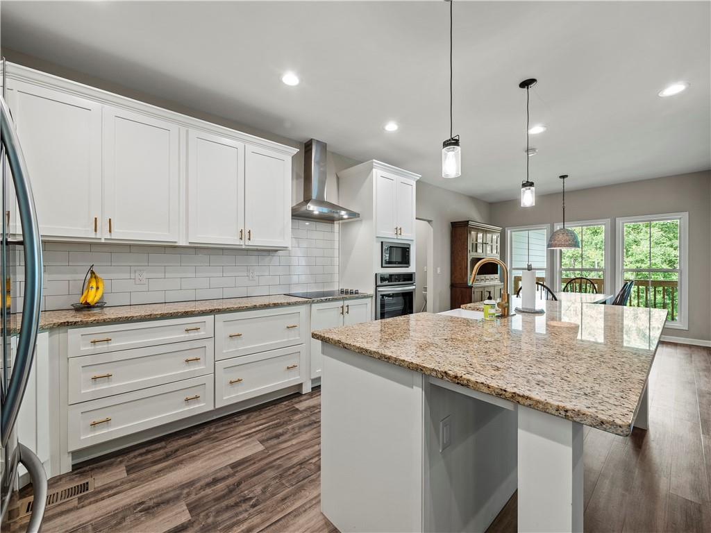 259 Cochran Road Talmo, GA 30575 - Photo 9 of 35 a kitchen with stainless steel appliances granite countertop a sink a stove and cabinets