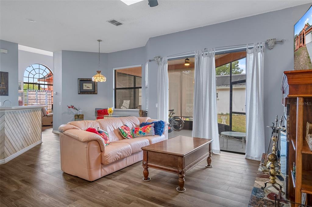 4401 Plumosa Street Spring Hill, FL 34607 - Photo 13 of 38 a living room with fireplace furniture and a window
