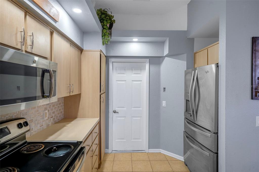 4401 Plumosa Street Spring Hill, FL 34607 - Photo 18 of 38 a kitchen with stainless steel appliances granite countertop a refrigerator and a stove