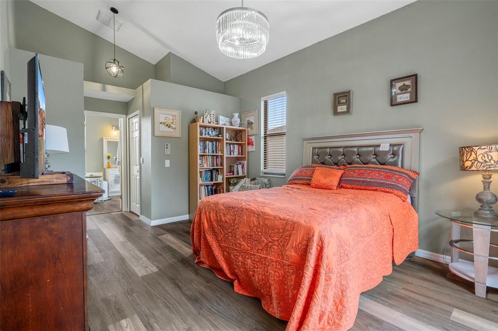 4401 Plumosa Street Spring Hill, FL 34607 - Photo 19 of 38 a bed room with a bed and a book shelf