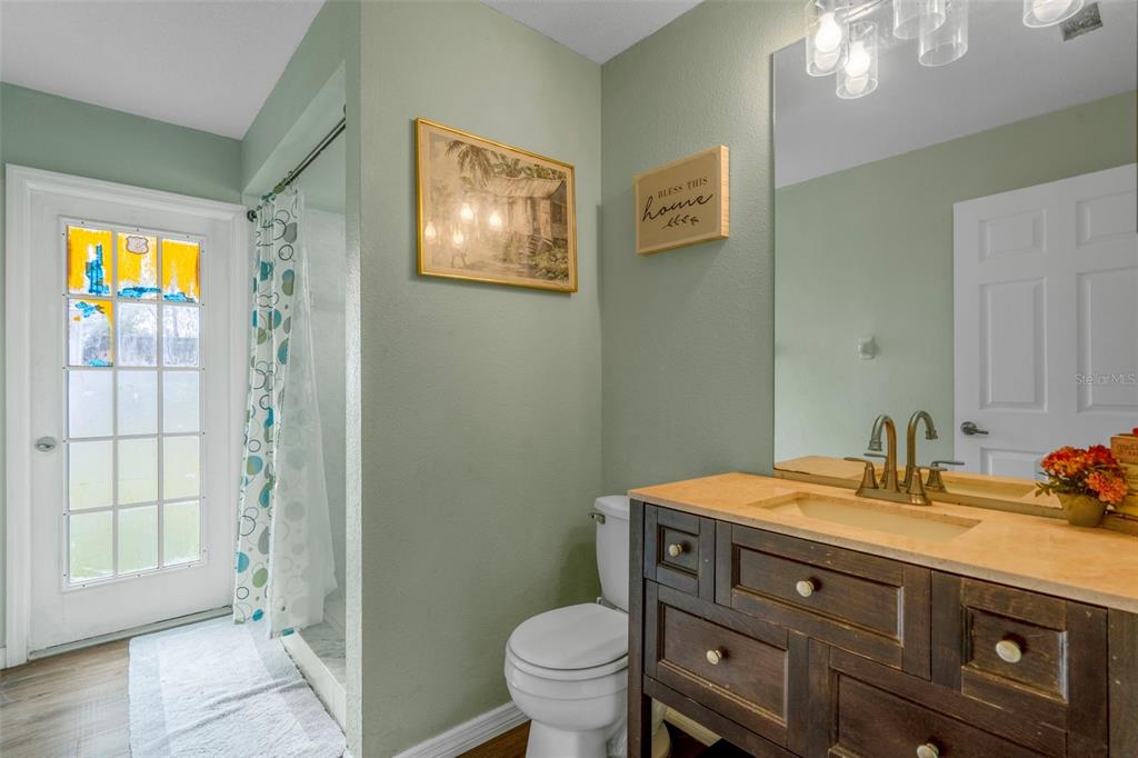 4401 Plumosa Street Spring Hill, FL 34607 - Photo 26 of 38 a bathroom with a sink a toilet and shower
