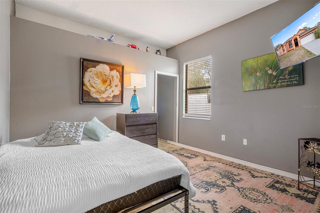 4401 Plumosa Street Spring Hill, FL 34607 - Photo 27 of 38 a bedroom with a bed and a flat screen tv