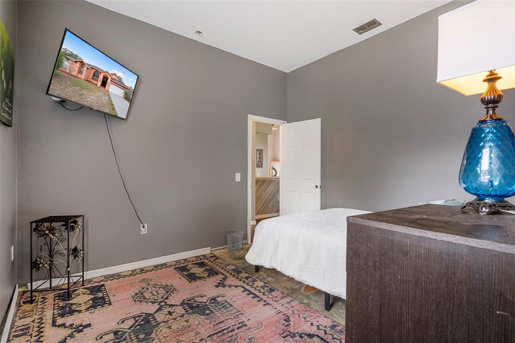 4401 Plumosa Street Spring Hill, FL 34607 - Photo 28 of 38 a bedroom with a bed and wooden floor