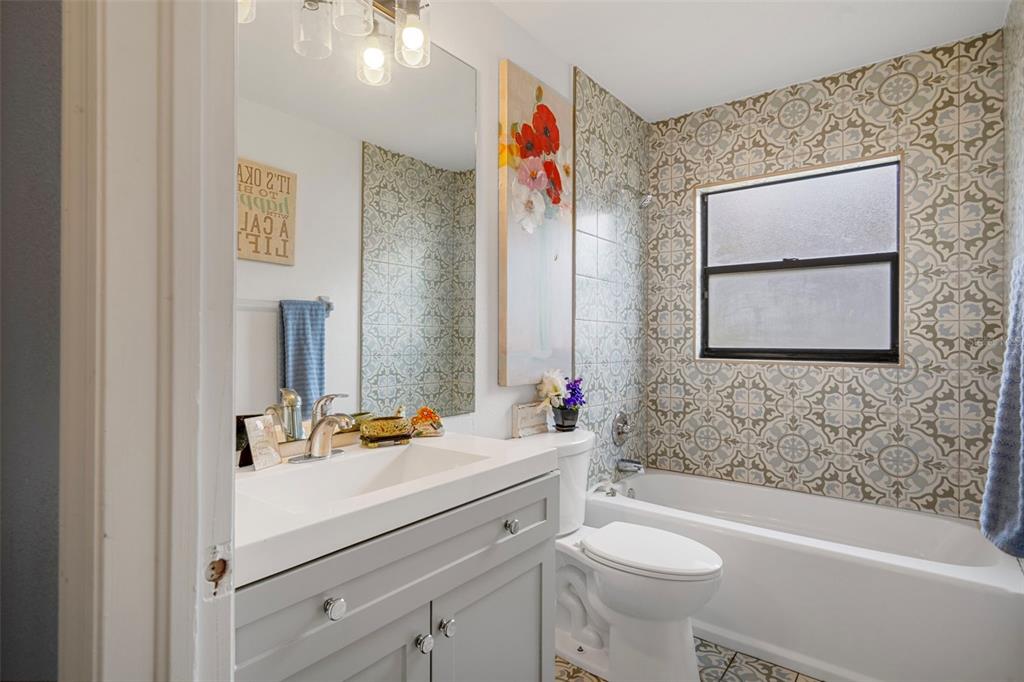 4401 Plumosa Street Spring Hill, FL 34607 - Photo 29 of 38 a bathroom with a sink vanity mirror and toilet