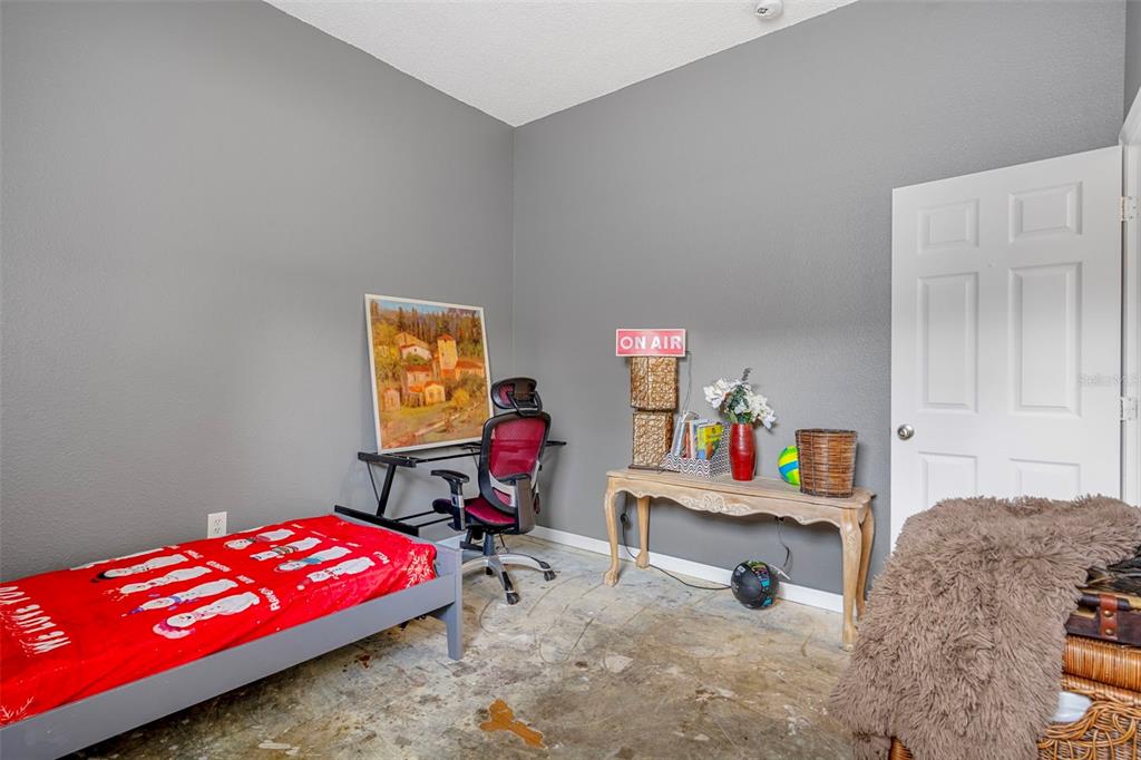 4401 Plumosa Street Spring Hill, FL 34607 - Photo 31 of 38 a bedroom with furniture and a couch