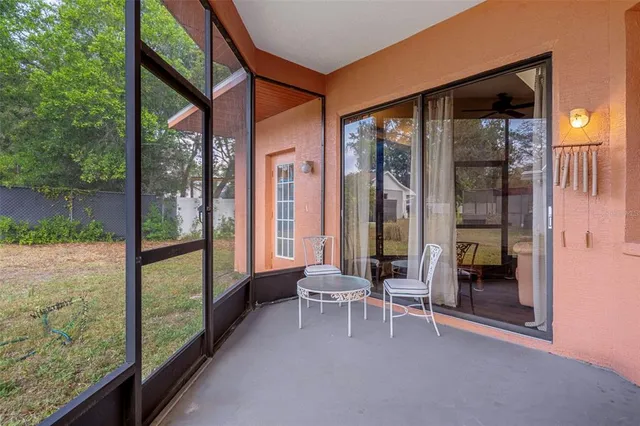 a balcony with chairs and a table