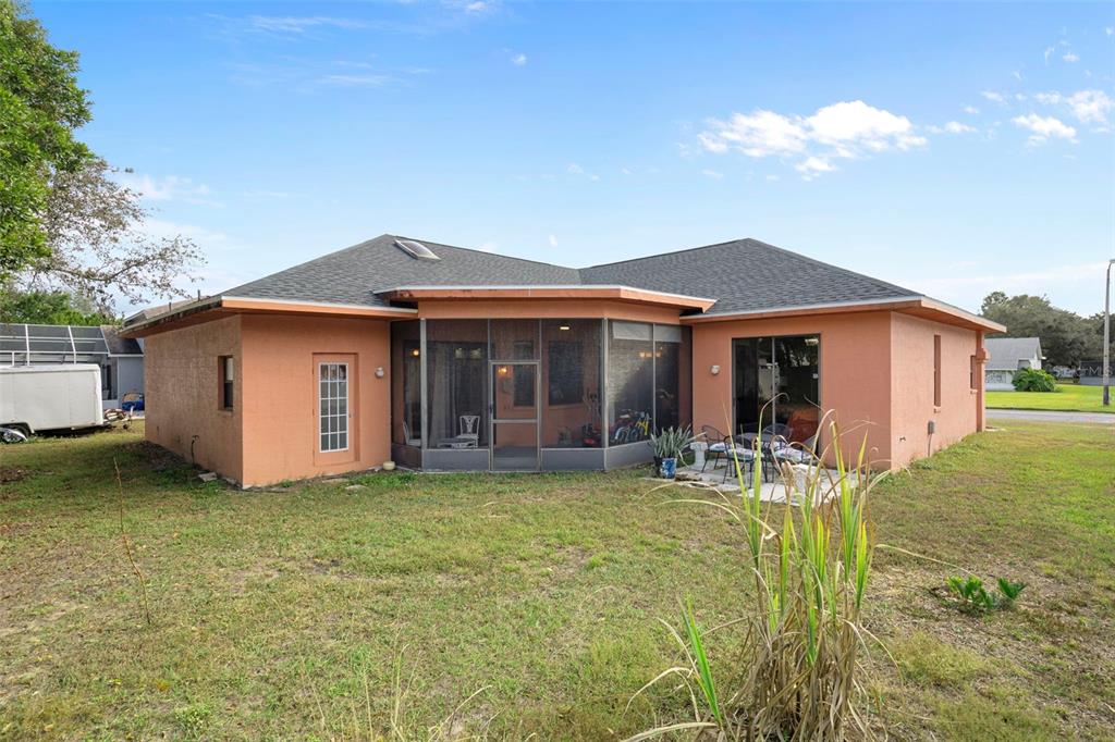 4401 Plumosa Street Spring Hill, FL 34607 - Photo 36 of 38 a front view of a house with garden
