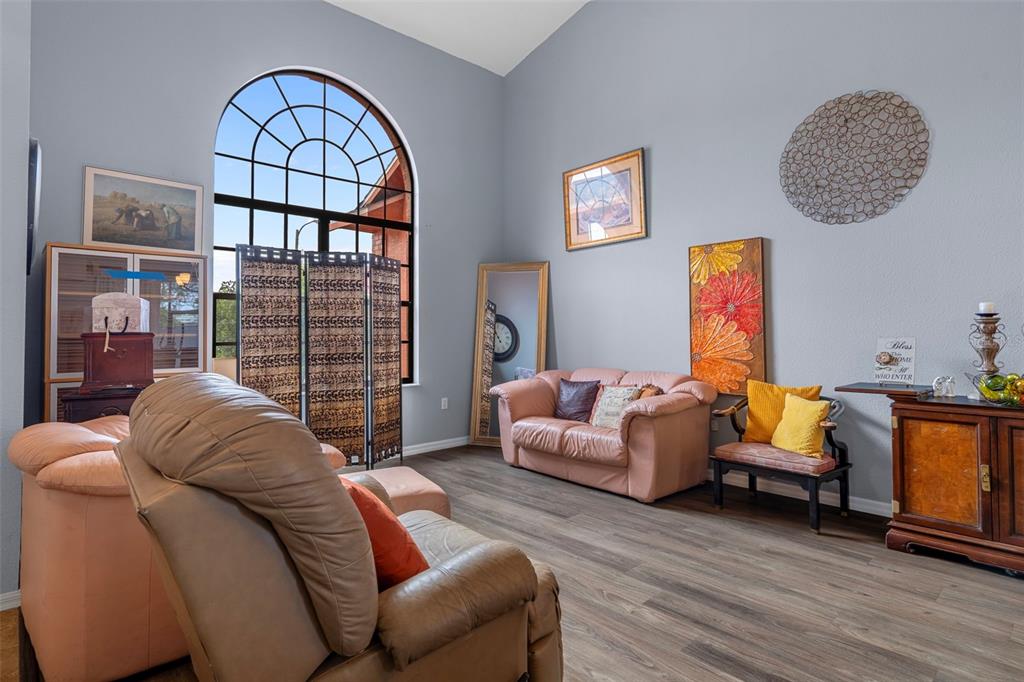 4401 Plumosa Street Spring Hill, FL 34607 - Photo 5 of 38 a living room with furniture a rug and a window
