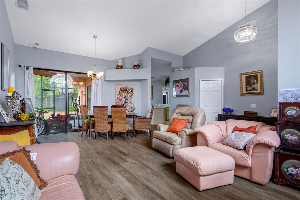 4401 Plumosa Street Spring Hill, FL 34607 - Photo 7 of 38 a living room with furniture fireplace and a large window