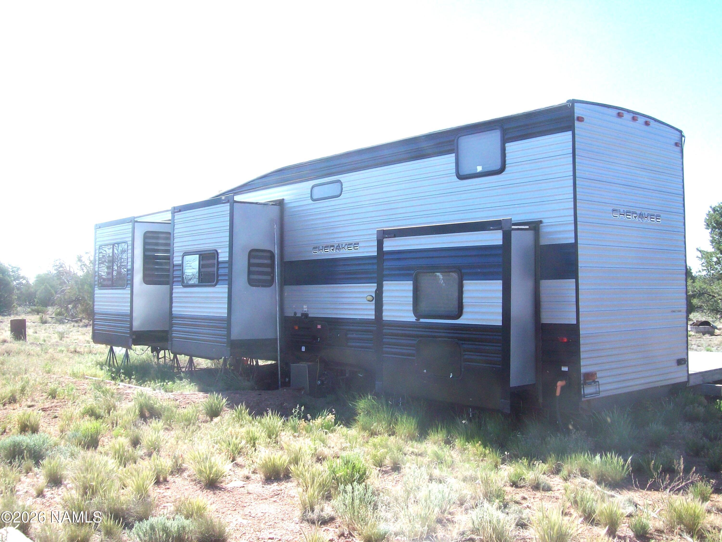 4063 East Woodland Ranch Road Williams, AZ 86046 - Photo 2 of 33 a front view of a house with a yard