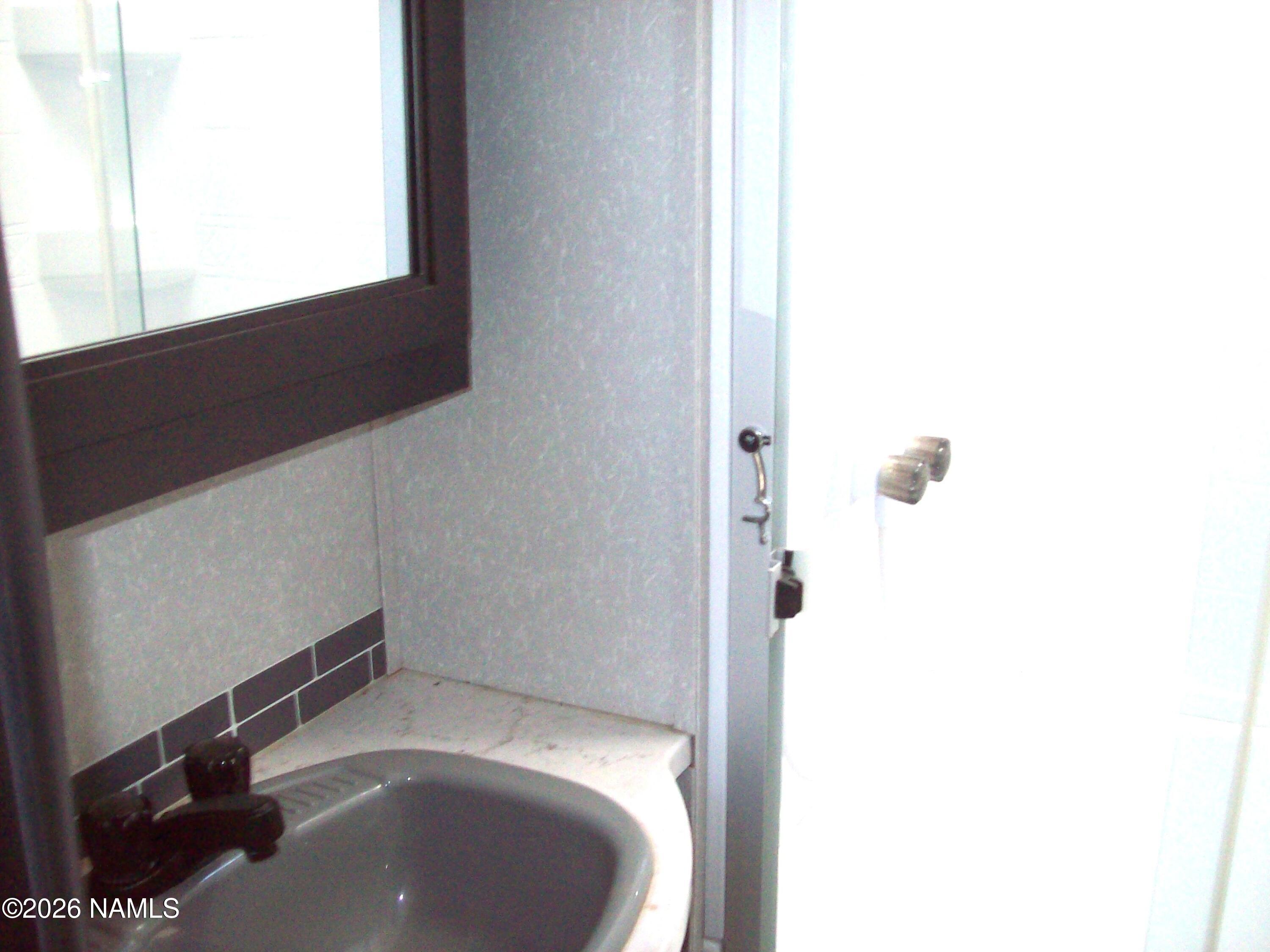 4063 East Woodland Ranch Road Williams, AZ 86046 - Photo 31 of 33 a bathroom with a sink and a vanity