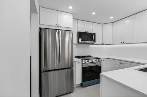 a kitchen with a refrigerator stove and microwave