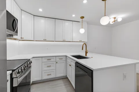 a kitchen with a sink and a refrigerator