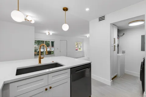a kitchen with kitchen island a counter space and a sink