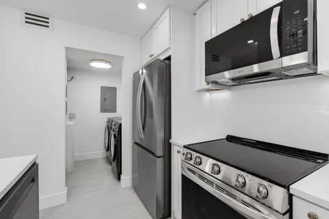 a kitchen with a refrigerator and a stove