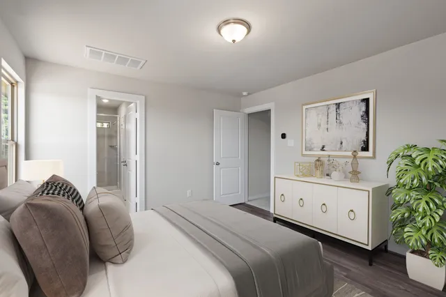 a bedroom with a bed and a chair