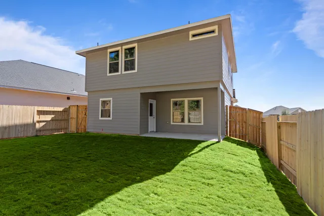 a view of a house with a yard and pathway